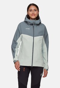Lys grå og skiferblå vandtæt jakke med hætte, udstyret med lynlåslommer og justerbare manchetter. Fremstillet af GORE-TEX materiale.