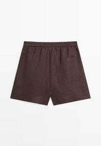 Brown linen shorts with an elastic waistband and a single patch pocket on the back right side, laid flat on a white background.