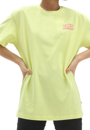 Light yellow cotton T-shirt with a crew neck and short sleeves. Features pink "VANS" logo on the left chest. Casual fit, smooth texture.