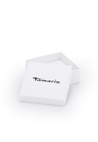 Weißer Papierbehälter mit offenem Deckel, auf dessen Oberseite das schwarze Logo "tamaris" gedruckt ist. Einfaches rechteckiges Design mit klaren Kanten.