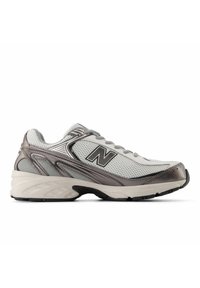 Gray and white athletic shoe with mesh upper, metallic accents, padded collar, and black rubber sole. Features a prominent "N" logo.