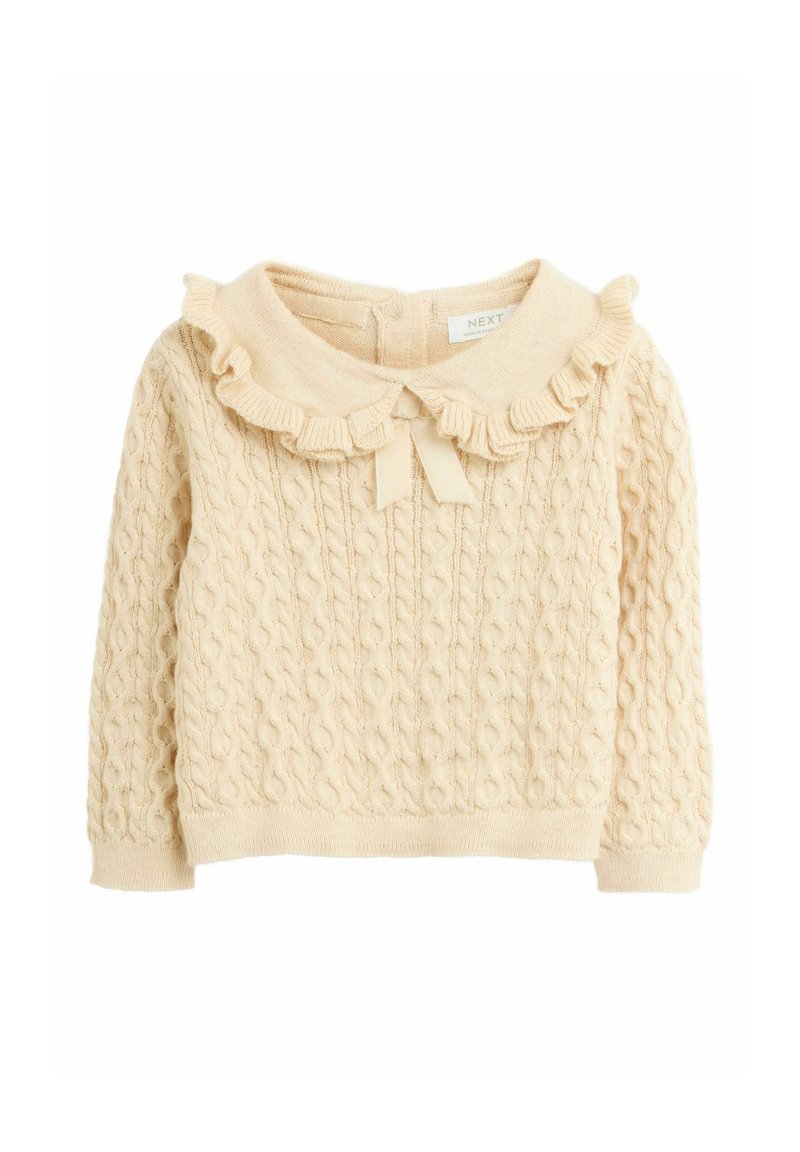Cream-colored knitted baby sweater with cable pattern, ruffled collar, and small bow at front center.