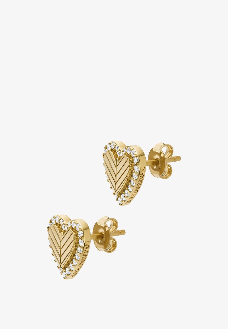 Pendientes de stud en forma de corazón dorado con un patrón de hojas y rodeados de pequeños cristales transparentes, con un acabado pulido y cierre de presión.