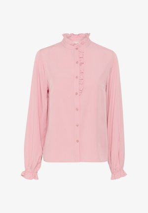 Világos rózsaszín, hosszú ujjú blúz fodros gallérral és elülső gombolással. Gombos záródással és rakott mandzsettákkal rendelkezik, amely laza illeszkedést biztosít.