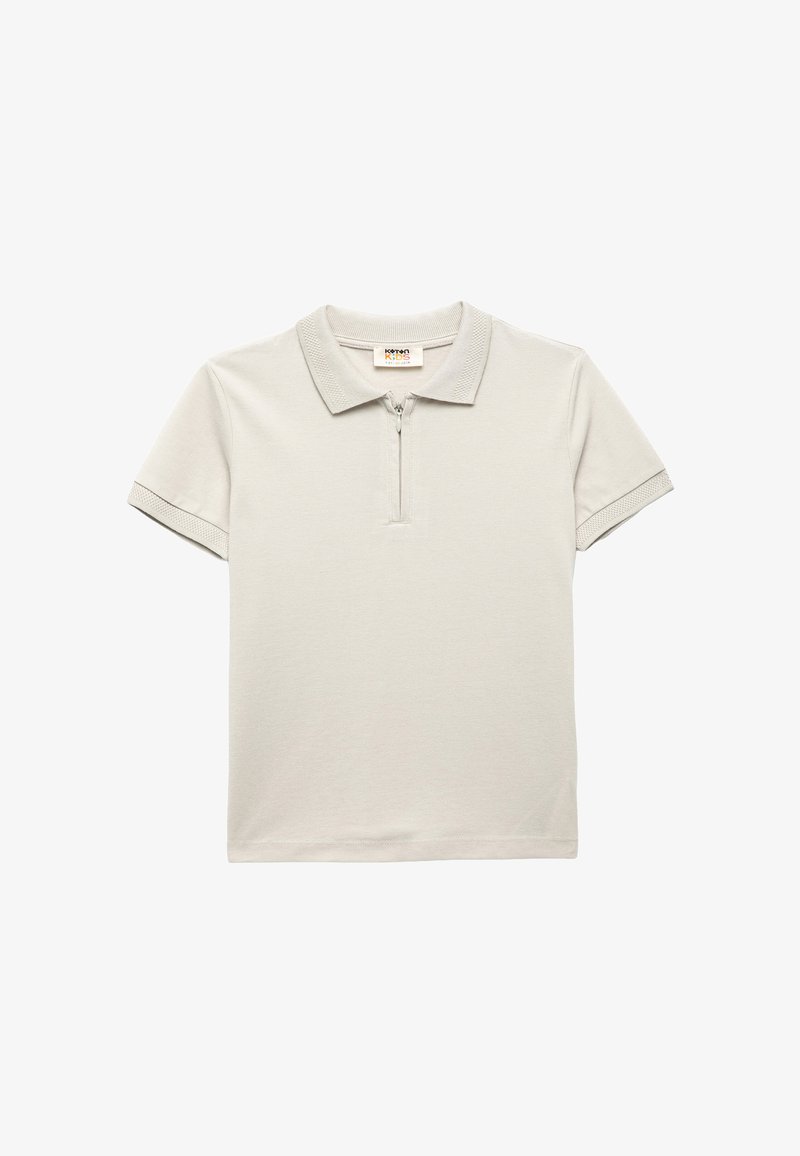 Polo de color gris claro hecho de algodón, con un cuello de media cremallera, mangas cortas con acentos estampados y un ajuste clásico.