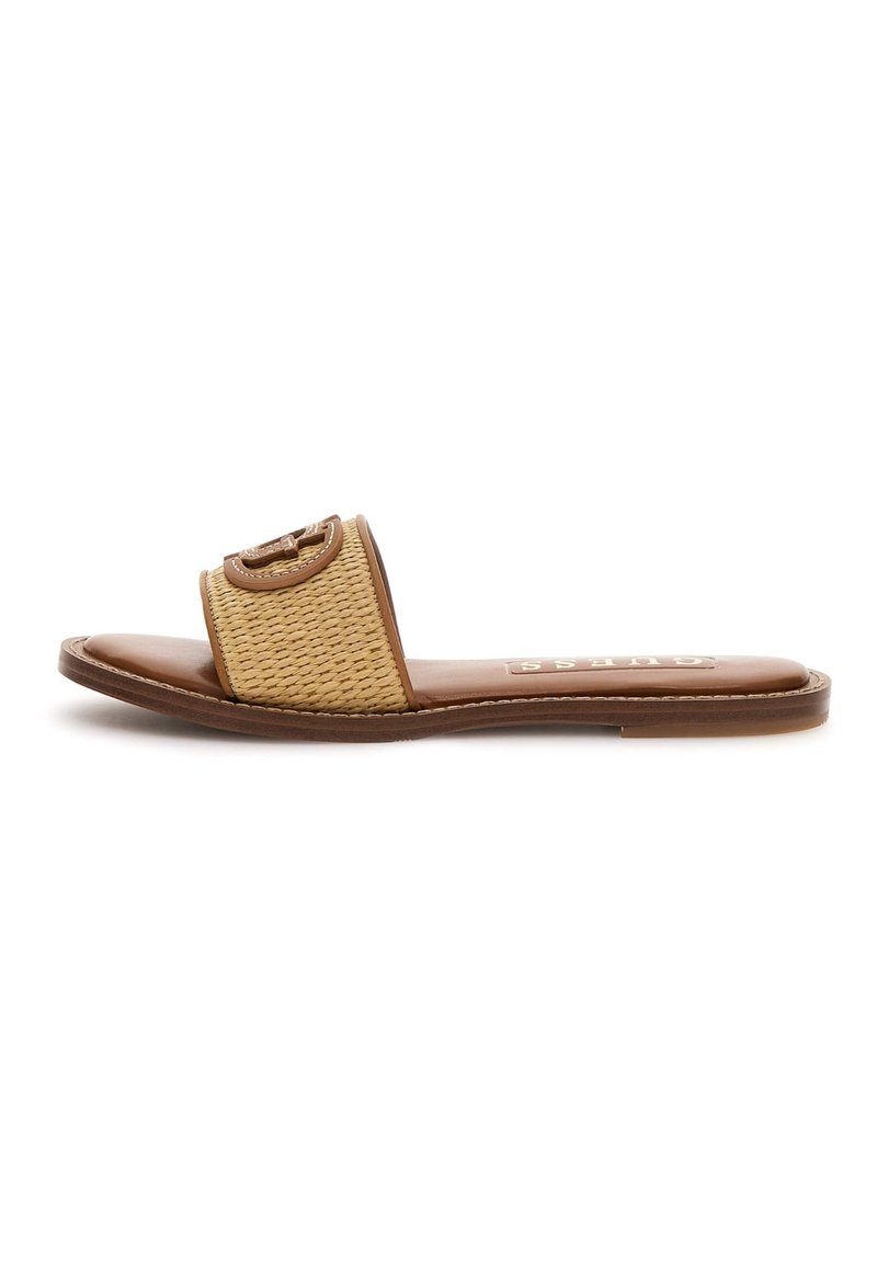 Tan slide sandal with a woven fabric upper and a smooth leather insole. Features a round logo accent on the strap. Flat sole.