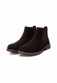 Botas de tobillo de ante marrón con paneles elásticos laterales, puntera redonda, costuras en contraste y un tacón bajo tipo bloque.