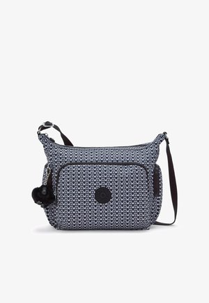 Textured crossbody bag in navy blue and white pattern, featuring a front zip pocket and a charm accent, with an adjustable strap.