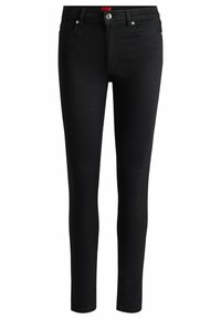 Jeans skinny in denim nero con un design aderente, hardware argentato, chiusura con zip e tasche posteriori; presenta un'etichetta rossa del marchio sulla vita.