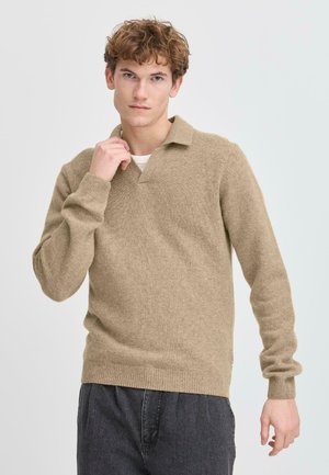 Beige knitted pullover with a V-neck and collar, made from soft wool blend, featuring ribbed cuffs and hem, and a textured finish.