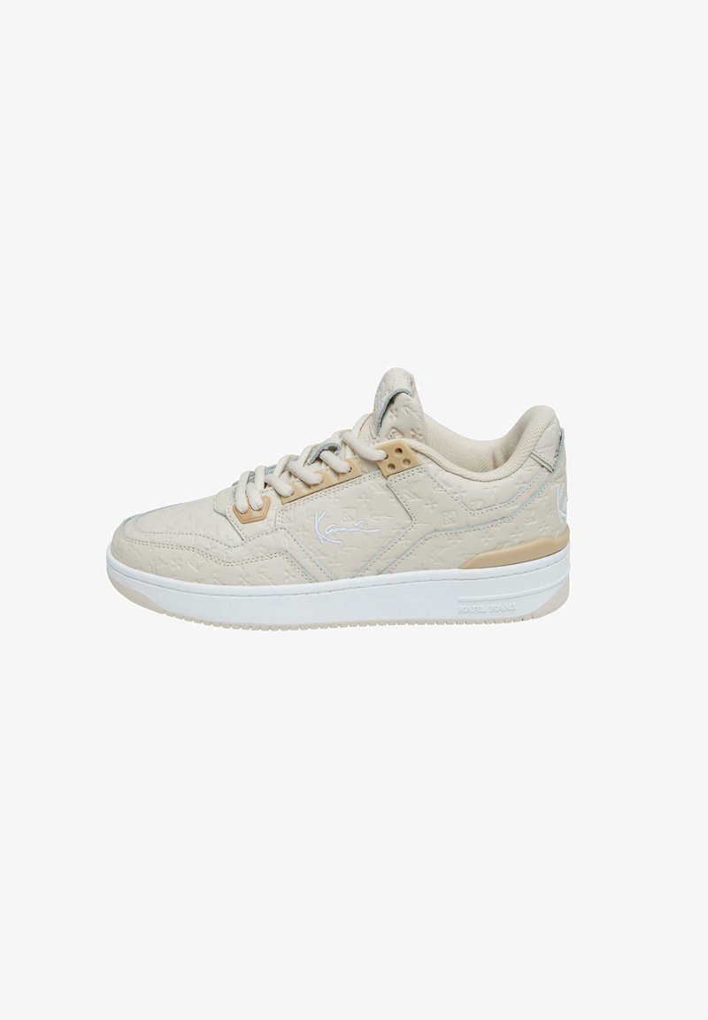 Bež paar sneakersid tekstuurse mustriga ja seotud disainiga. Omab pehmendatud kaelust ja kummist talda, millel on külgedel diskreetne logoaktsent.