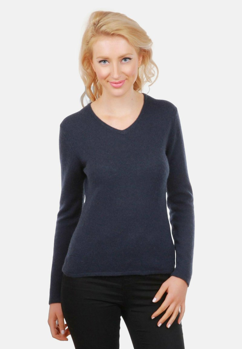 Pull à manches longues bleu marine avec un design en V, fabriqué dans une texture douce, de forme ajustée, avec des poignets et un ourlet côtelés.