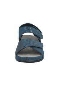 Blue sandal featuring a textured fabric upper with floral pattern, dual straps, open toe, and soft suede-like footbed.