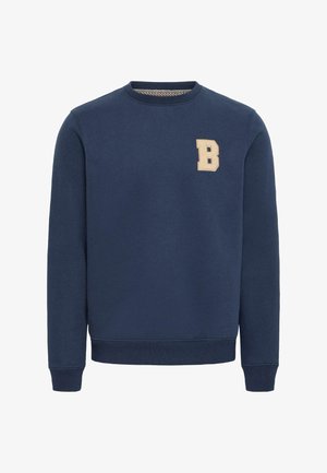 Tumši zilas krāsas džemperis, kas izgatavots no mīkstas auduma, ar apaļu izgriezumu un ribota raksta aprocēm. Uz krūtīm ir izšūts bēšs "B" logotips.
