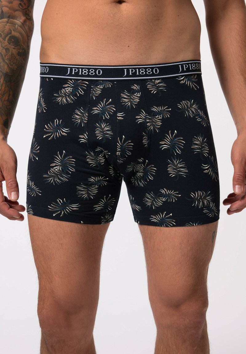 Navy blue boxers with a palm leaf pattern in beige and teal. Features an elastic waistband with "JP1880" logo. Made of soft, stretch fabric.