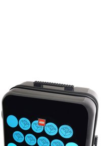 Black hard-shell LEGO case with a zipper, featuring blue circular designs of LEGO bricks and a red LEGO logo on the front. Textured grip handle.