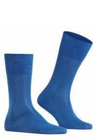 Calcetines de algodón azules con una textura suave, puños acanalados y un diseño por encima de la rodilla. Presentan un color sólido sin patrones ni adornos.