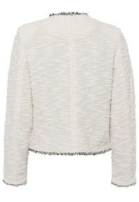 Biała teksturowana kurtka o skróconym kroju, z czarnymi frędzlami wzdłuż dekoltu i mankietów oraz długimi rękawami.