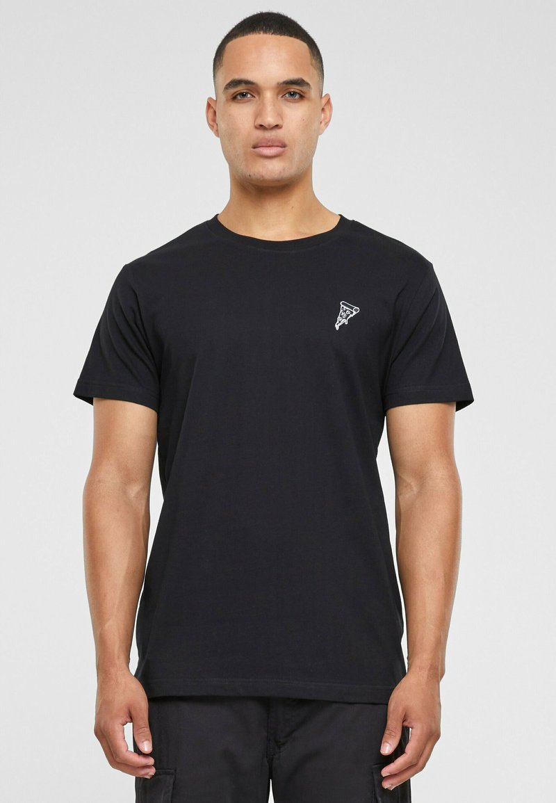 Black cotton t-shirt featuring short sleeves and a crew neck. Notable white graphics on the left chest area, with a simple, smooth texture.