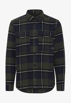 Tumedast rohelisest ja tumesinistest ruudulistes mustrites flanell särk. Omab nööpidega esiosa, kahte rinna taskut ja klassikalist kraed. Pehme tekstuur.