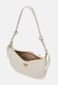 White leather shoulder bag with a curved shape, adjustable strap, gold hardware, and a zip closure. Interior features brown lining and pockets.