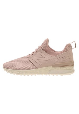 Light pink athletic sneaker with mesh upper, padded collar, laces, and textured beige sole facing left.