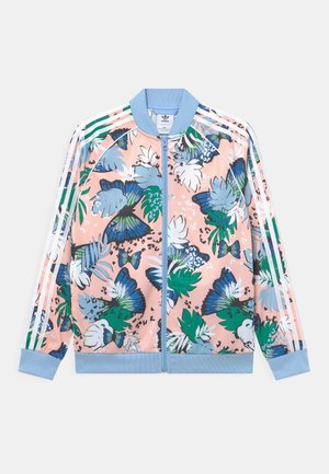 Blommig tryckt zip-jacka med blå och rosa nyanser, tillverkad av polyester, med ribbade muddar och nederkant, samt tre vita ränder på ärmarna.