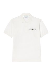 Polo bianco in cotone, con logo ricamato verde e nero e colletto con due bottoni. Maniche corte con polsini a coste.