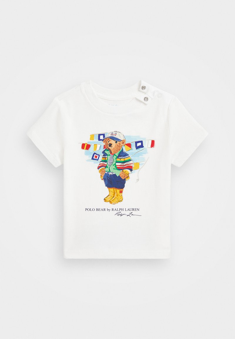 White cotton t-shirt featuring a colorful bear illustration in a jacket and boots, with button accents on the shoulder and printed logo.