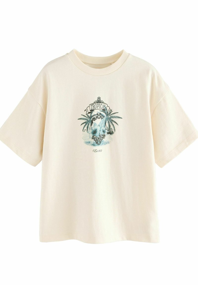 T-shirt en coton couleur crème à manches courtes, avec un motif de palmier et le texte "TROPICAL" en teal. Coupe décontractée et texture douce.