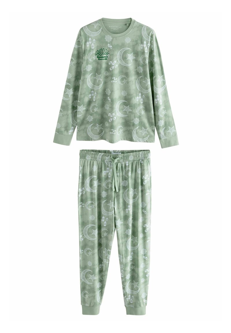 Green pajama set featuring a long-sleeve top and matching pants. Fabric has a soft texture with a pattern of moons and stars in white.