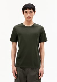 Dark green cotton t-shirt with a round neck and short sleeves, featuring a smooth texture and a relaxed fit. No visible patterns or logos.