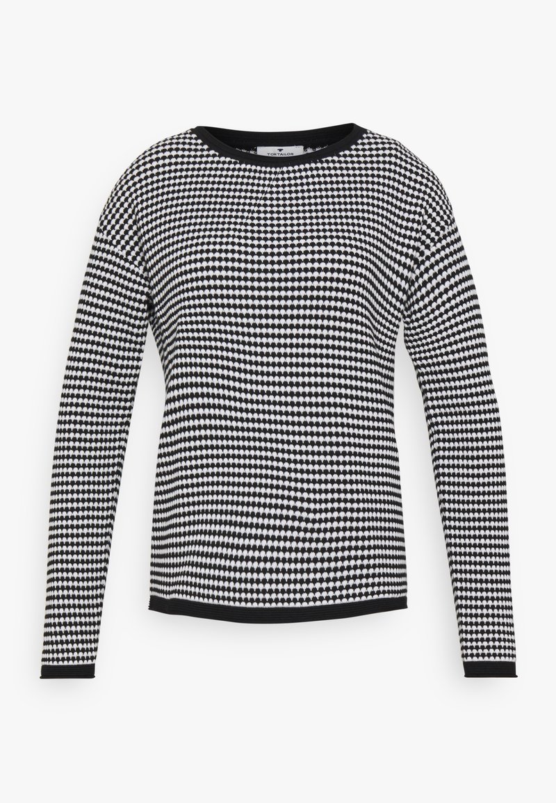 Maglione a maniche lunghe bianco e nero con un motivo geometrico, scollatura rotonda e bordi neri a contrasto.