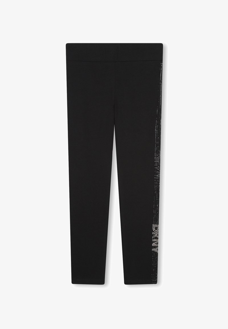 Leggings noirs en tissu lisse et extensible. Présentent une ligne verticale de décorations brillantes sur le côté externe.