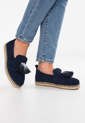 Espadrillas in suede blu navy con un nappina decorativa, suola in juta intrecciata beige e lati aperti. Indossate con jeans in denim arrotolati.