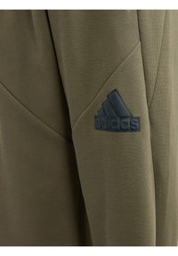 adidas Performance FUTURE ICON - Pantalones deportivos - olive strata   black