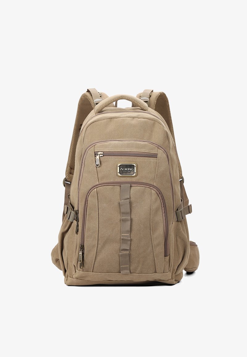 Zaino in tela khaki con accenti marroni, presenta numerose tasche frontali con zip, spallacci imbottiti e un manico robusto sulla parte superiore.
