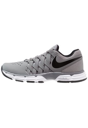 Grijze Nike hardloopschoen met zwarte swoosh, geweven veterdesign, gevoerde witte zool met het label "Lunarlon" en zwarte profiel details.