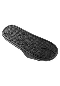 Black rubber shoe sole with textured surface. Features zigzag patterns and a smooth edge, designed for traction and durability.