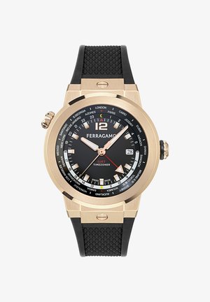 Hodinky Ferragamo GMT Timezoner s černým ciferníkem, zlatým pouzdrem, gumovým řemínkem a s vyznačenými světovými časovými zónami na lunetě.