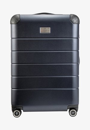 Granatowy twardy walizka z żebrowym wzorem, zaokrąglonymi rogami, podwójnymi kółkami i płytką z logo. Podwójne uchwyty ułatwiające przenoszenie.