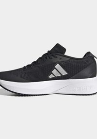 Black athletic shoe with a breathable mesh upper, lightweight design, white midsole, and textured rubber outsole. Features a distinct logo.