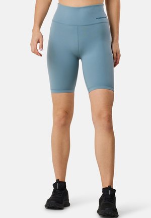 Short, high-waisted bike shorts in a soft, light blue fabric. Features a seamless design and a logo on the waistband.