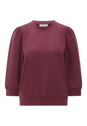 Bordowa bluza wykonana z miękkiego materiału, z okrągłym dekoltem i bufkami na rękawach, o lekko luźnym kroju i ściągaczach na mankietach.