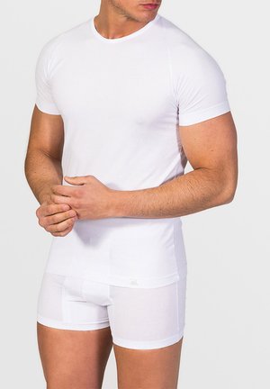 White fitted T-shirt with short sleeves, made of smooth fabric, paired with matching white boxer briefs, showcasing a seamless design.