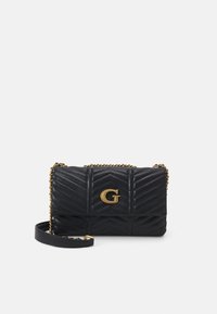 Sort quiltet læderhåndtaske med et guld "G" logo, kædestropp, og detaljer med zigzag mønster. Kompakt rektangulær form.