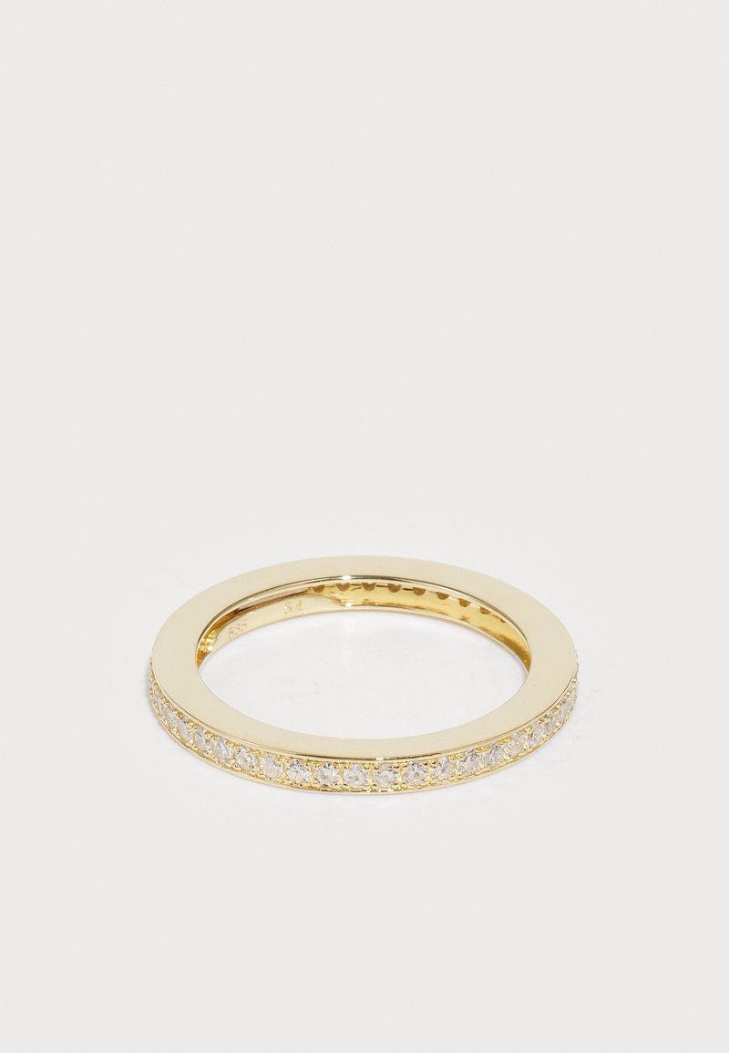 Auksinis žiedas su lygiu, blizgiu paviršiumi ir skaidriais, blizgančiais akmenimis, suformuotais eilute palei išorinį žiedą. Apvalios formos, ploną profilį.