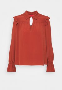 Rustfarbige Bluse mit Kragen, Schlüsselspaltschnitt und gerafften Schulterdetails. Lange Ärmel mit gerafften Manschetten, aus leichtem Stoff gefertigt.