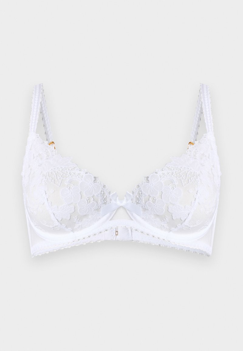 Soutien-gorge en dentelle blanche avec broderie florale, bretelles doubles réglables, nœud en satin au centre et armatures de maintien.