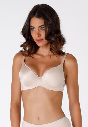 Seno beige imbottito con bordi in pizzo ondulato, texture liscia e spalline regolabili. Presenta un design classico e una costruzione senza cuciture.